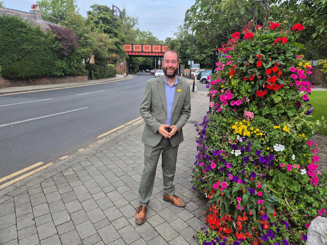 Cllr Mark Roberts, Leader of Stockport Council, in Cheadle by the railway bridge, in a photo issued with the council's announcement