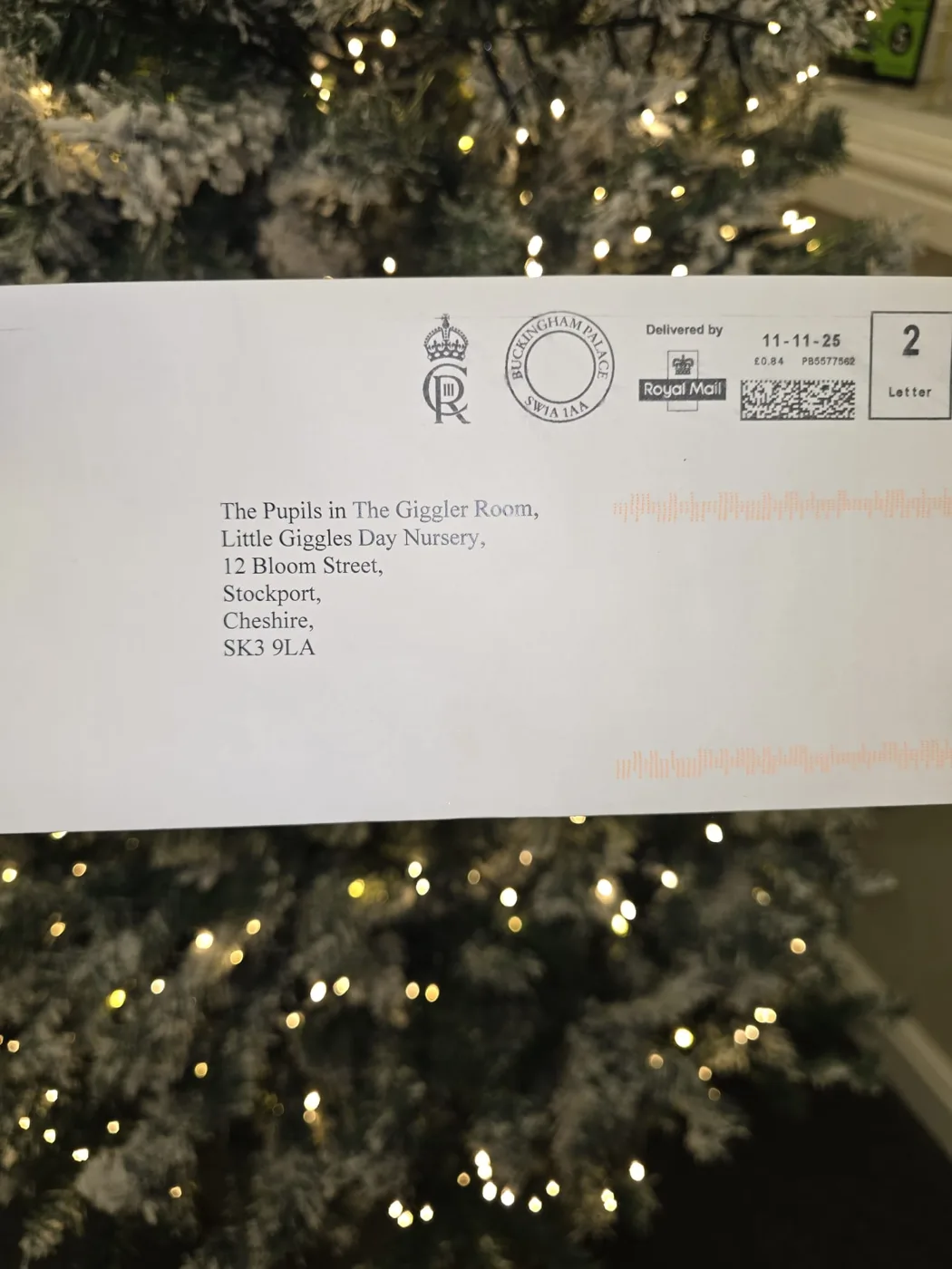 A Buckingham Palace envelope with a royal cypher, addressed to The Pupils in The Giggler Room, Little Giggles Day Nursery, Bloom Street, Stockport