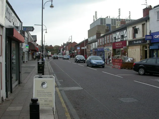 Cheadle High Street, with the sign for Massie Street on the left. The banned right turn from Massie Street on to High Street is one of the first two camera sites.