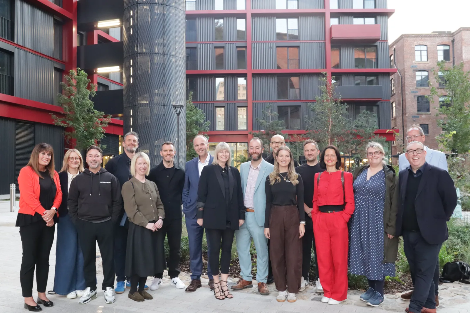 Partners and guests at the Weir Mill completion event in September, with the new-build block behind them
